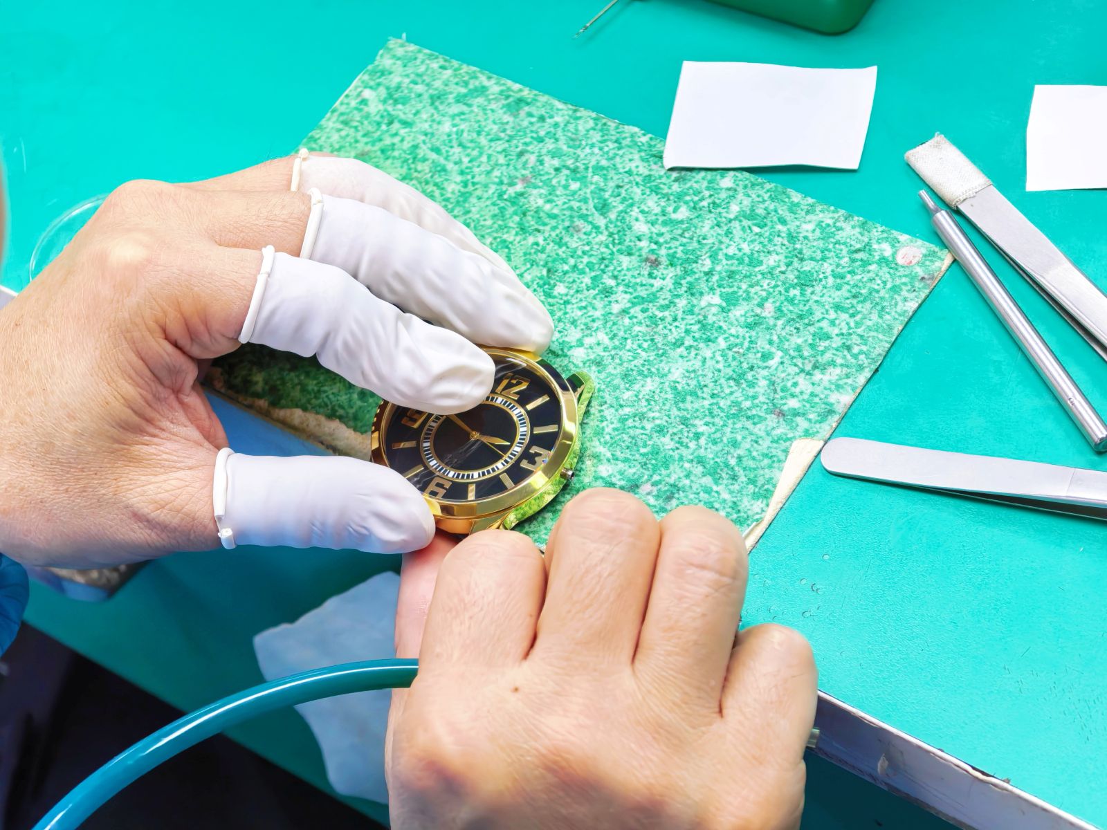 Close-up dial handling stage during OEM watch production.
